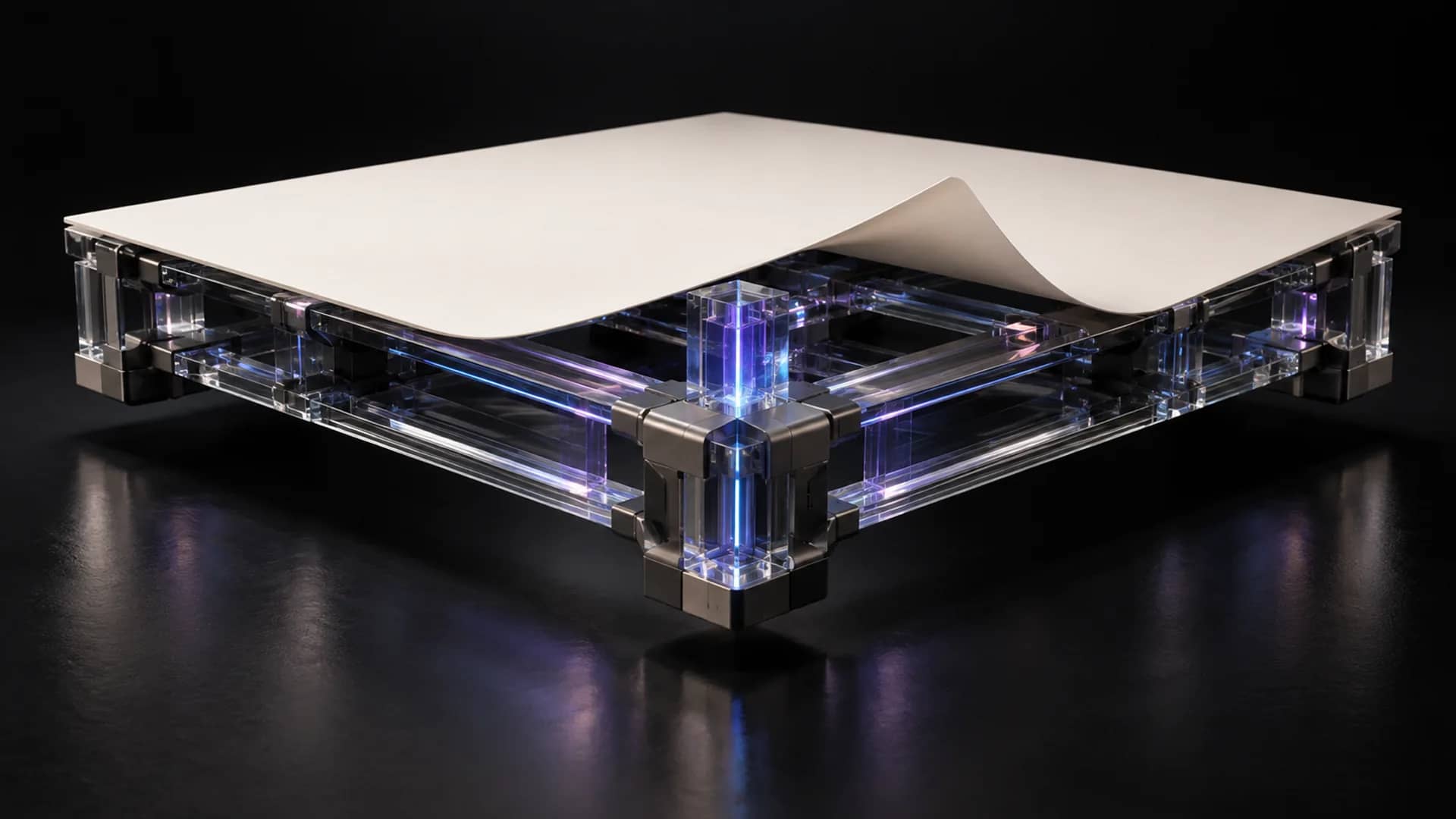 A pale sheet with one corner curled up rests on a clear glass frame with metal corner blocks, lit blue and violet against black.