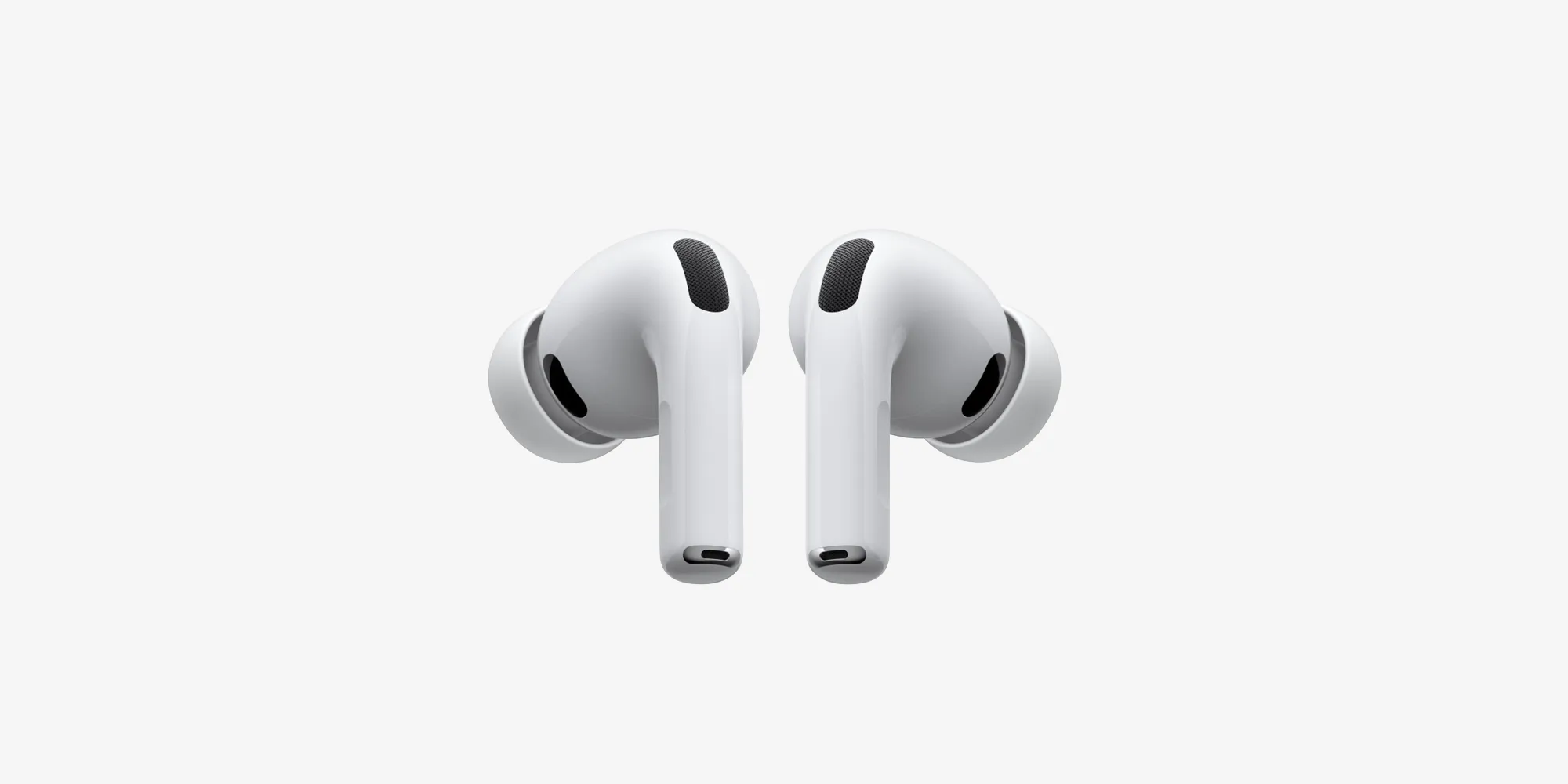 A pair of white Apple AirPods Pro on a clean light gray background, an example of minimal, restrained product design